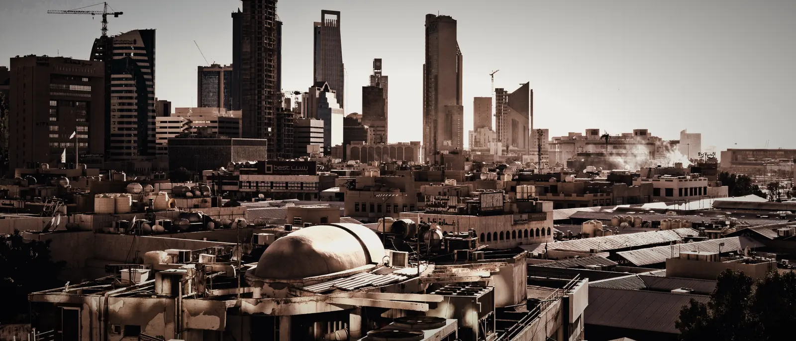 The Riyadh skyline: its towers and construction cranes at sunset